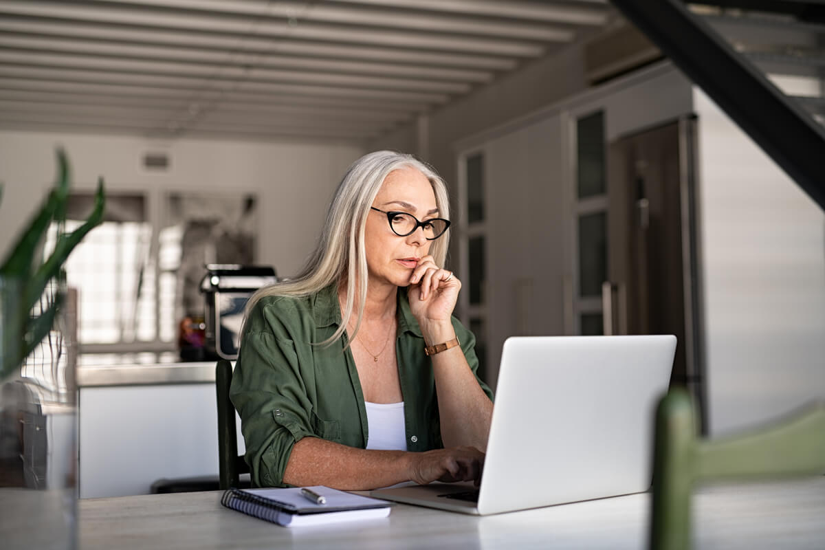 Woman researching Phishing Scams on her computer